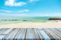 Wooden table ÃÂ top with blurred natural sea of tropical beach and blue sky, summer holiday background ideas for display Royalty Free Stock Photo